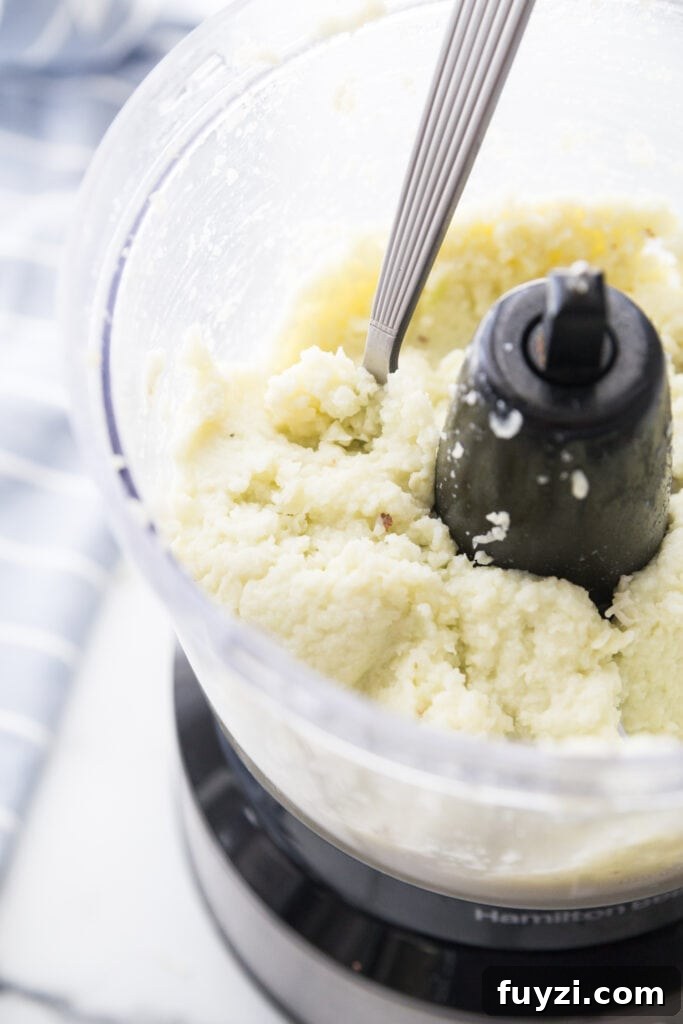 A photo of cauliflower mash in a food processor