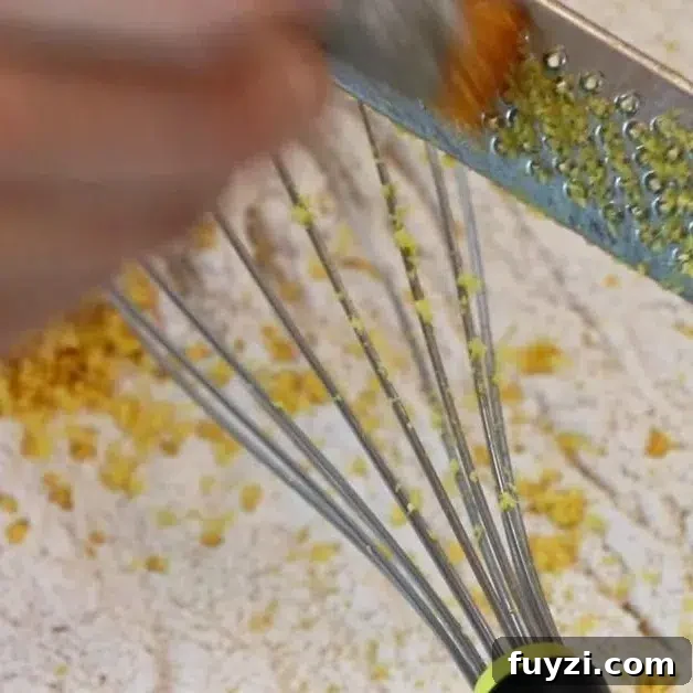 zesting lemon over dry ingredients