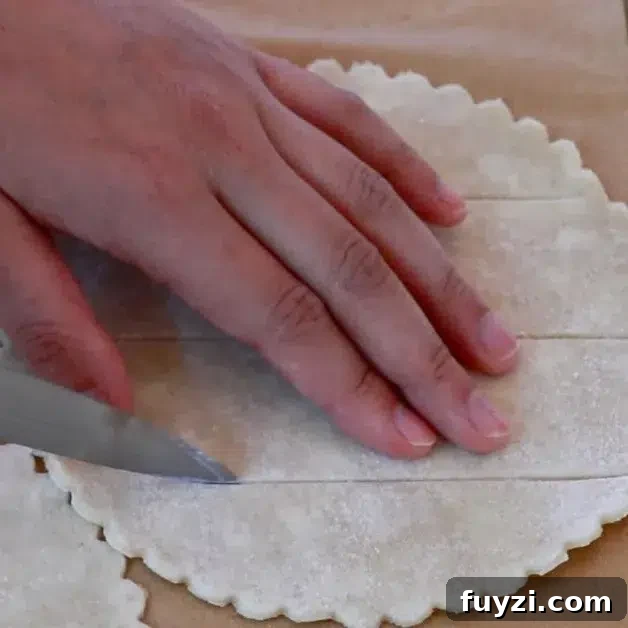 cutting the surface of pie dough for blueberry pie