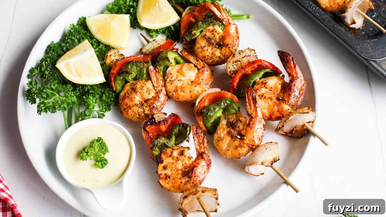 27 Crowd-Pleasing Outdoor Potluck Recipes for Late Summer 27 Grilled shrimp skewers with red and green bell peppers, served with lemon wedges and a dipping sauce on a white plate.