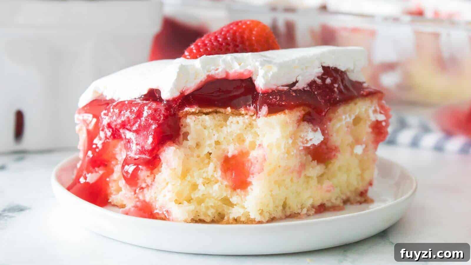 27 Crowd-Pleasing Outdoor Potluck Recipes for Late Summer 6 A slice of strawberry poke cake with white frosting and strawberry topping on a white plate.