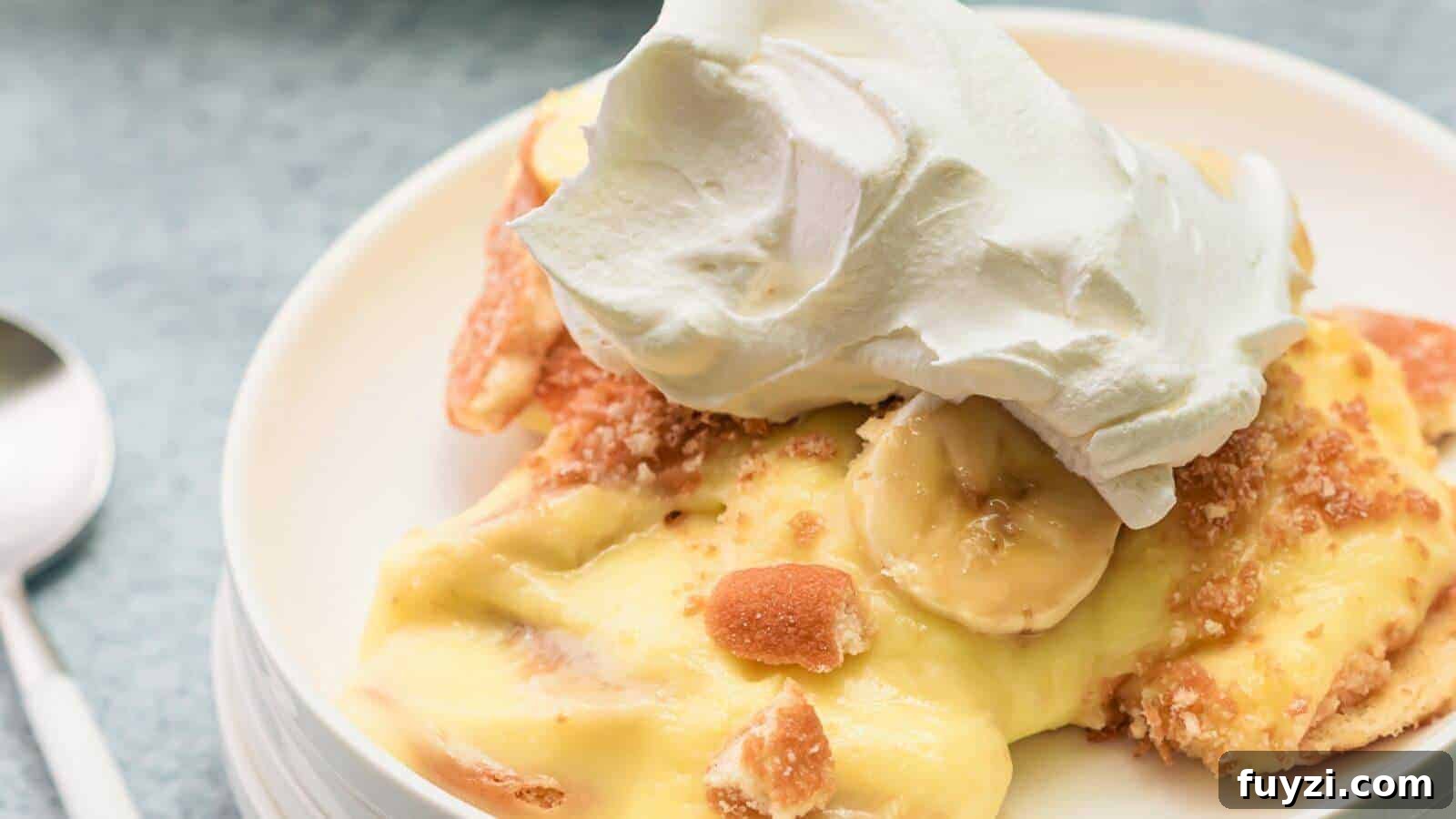 27 Crowd-Pleasing Outdoor Potluck Recipes for Late Summer 7 Slice of banana pudding topped with whipped cream on a white plate.