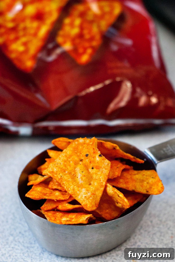 Doritos in a silver measuring cup.