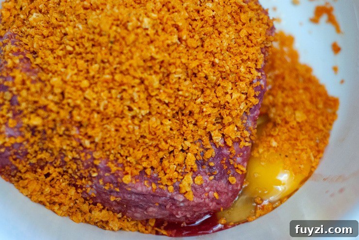 Crushed Doritos mixed with a burger patty and egg.