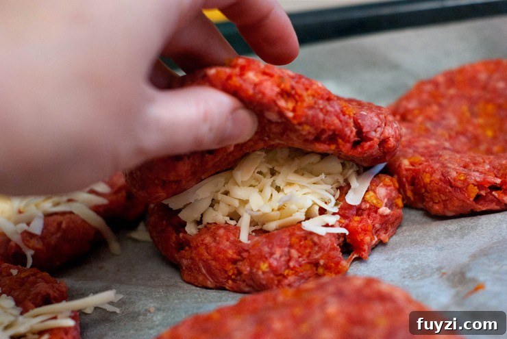 Stuffing shredded Pepper Jack cheese into Dorito Burger patties.