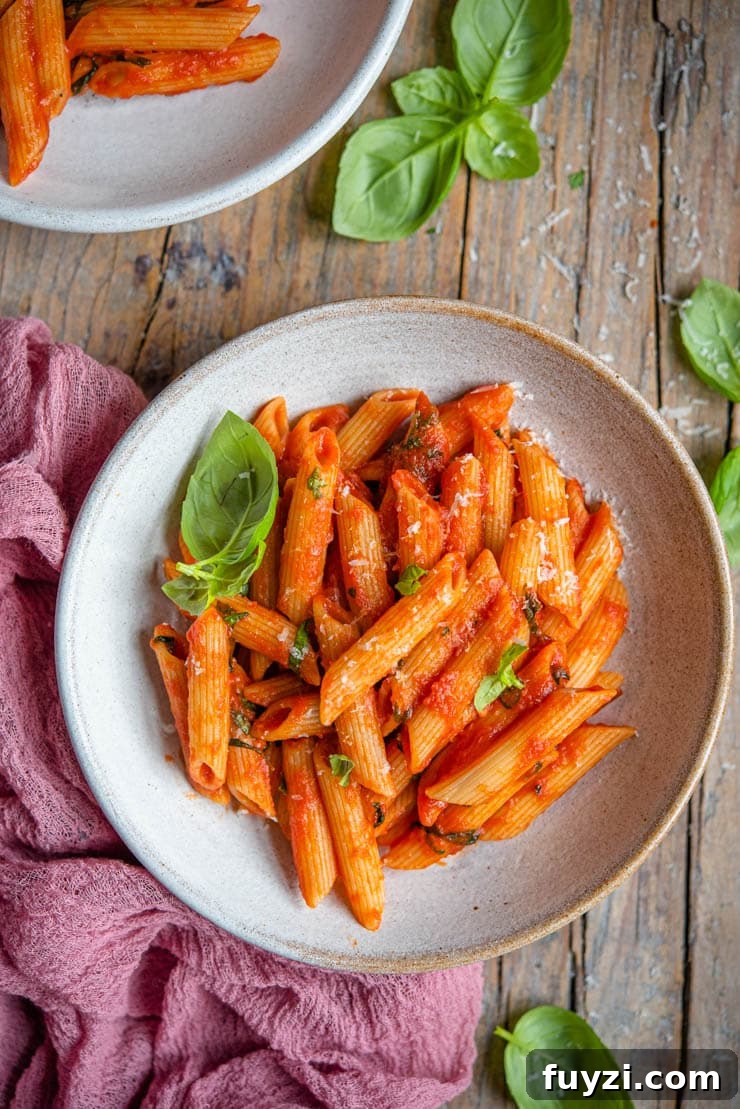 Penne Pomodoro: Classic Tomato Basil Pasta Recipe 2 An overhead shot of tomato pasta in a bowl with basil