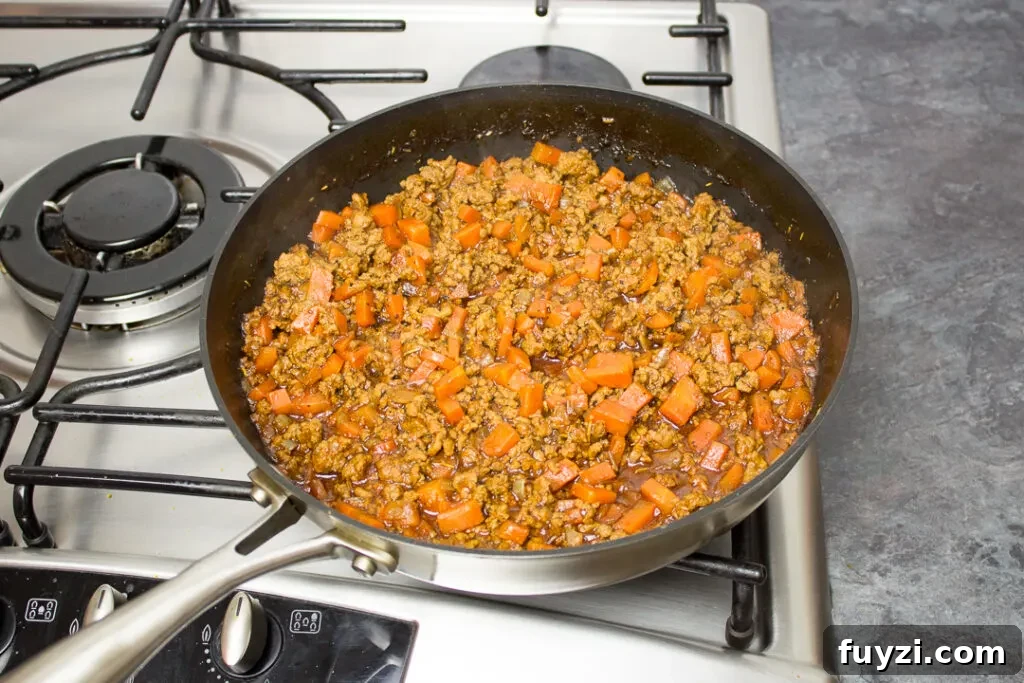 Fully cooked mince and vegetable Shepherd's pie filling in a saucepan, ready to be used.