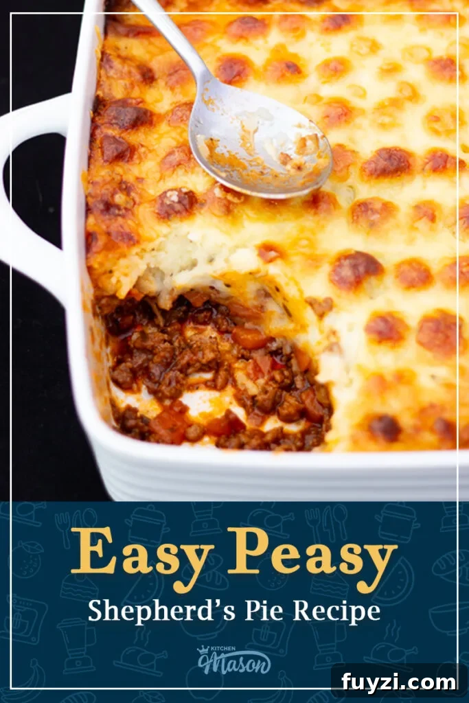 Shepherd's pie in a square white roasting dish with a dirty spoon on top, and a portion spooned out. A text overlay says 'Easy peasy Shepherd's pie recipe'.