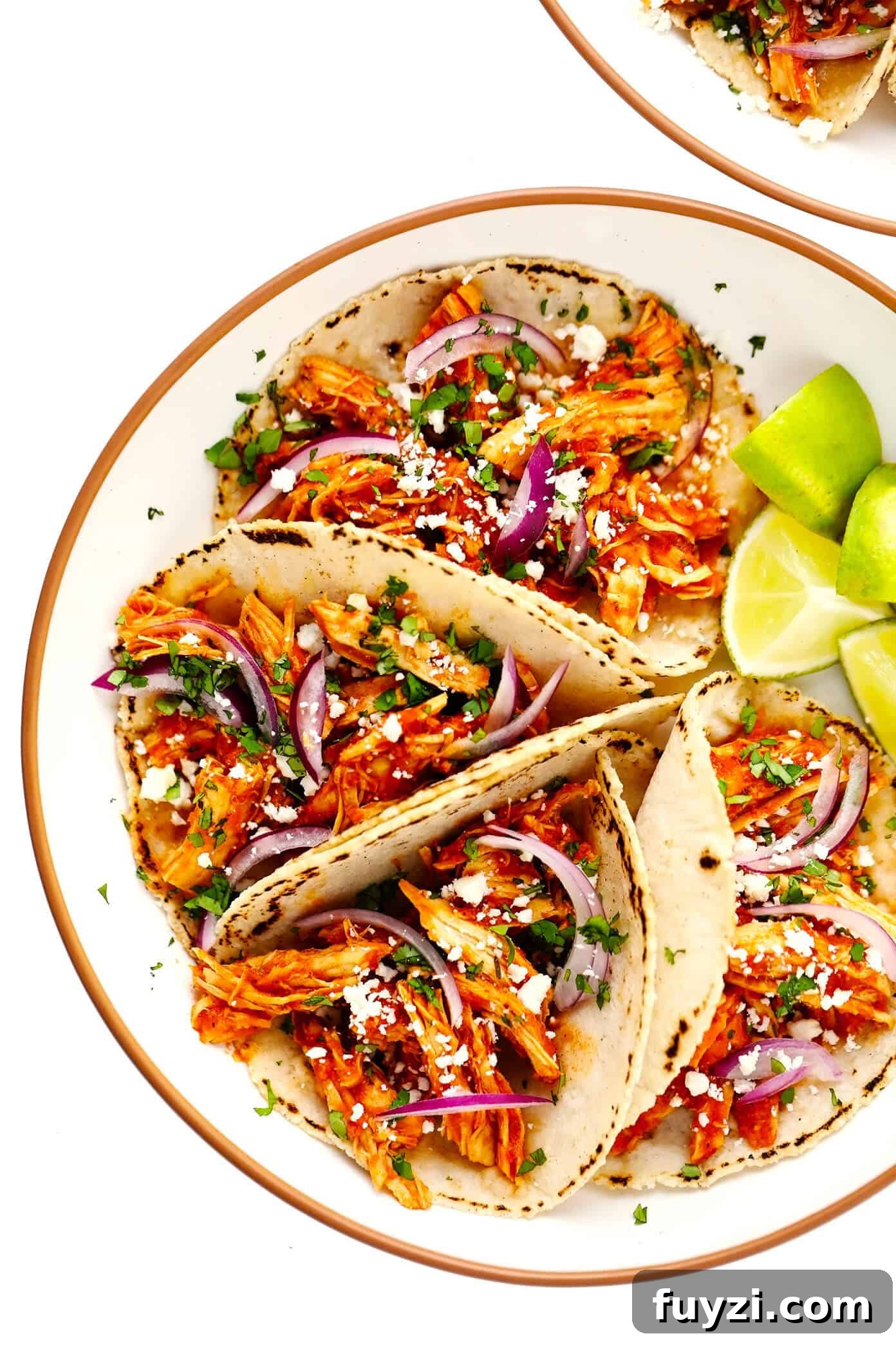 Serving bowls of Chicken Tinga Tacos with lime wedges Chicken Tinga Tacos in Bowls with Limes