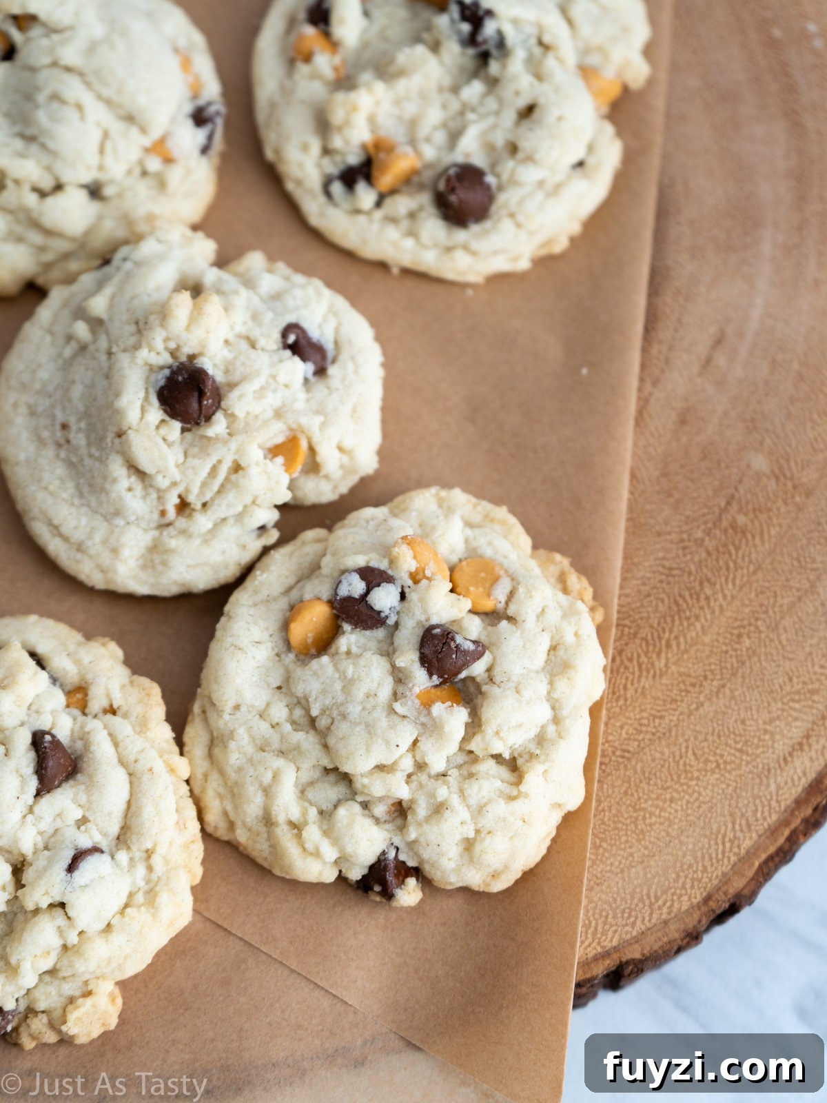 Close-up of butterscotch chip cookies on a brown surface. 