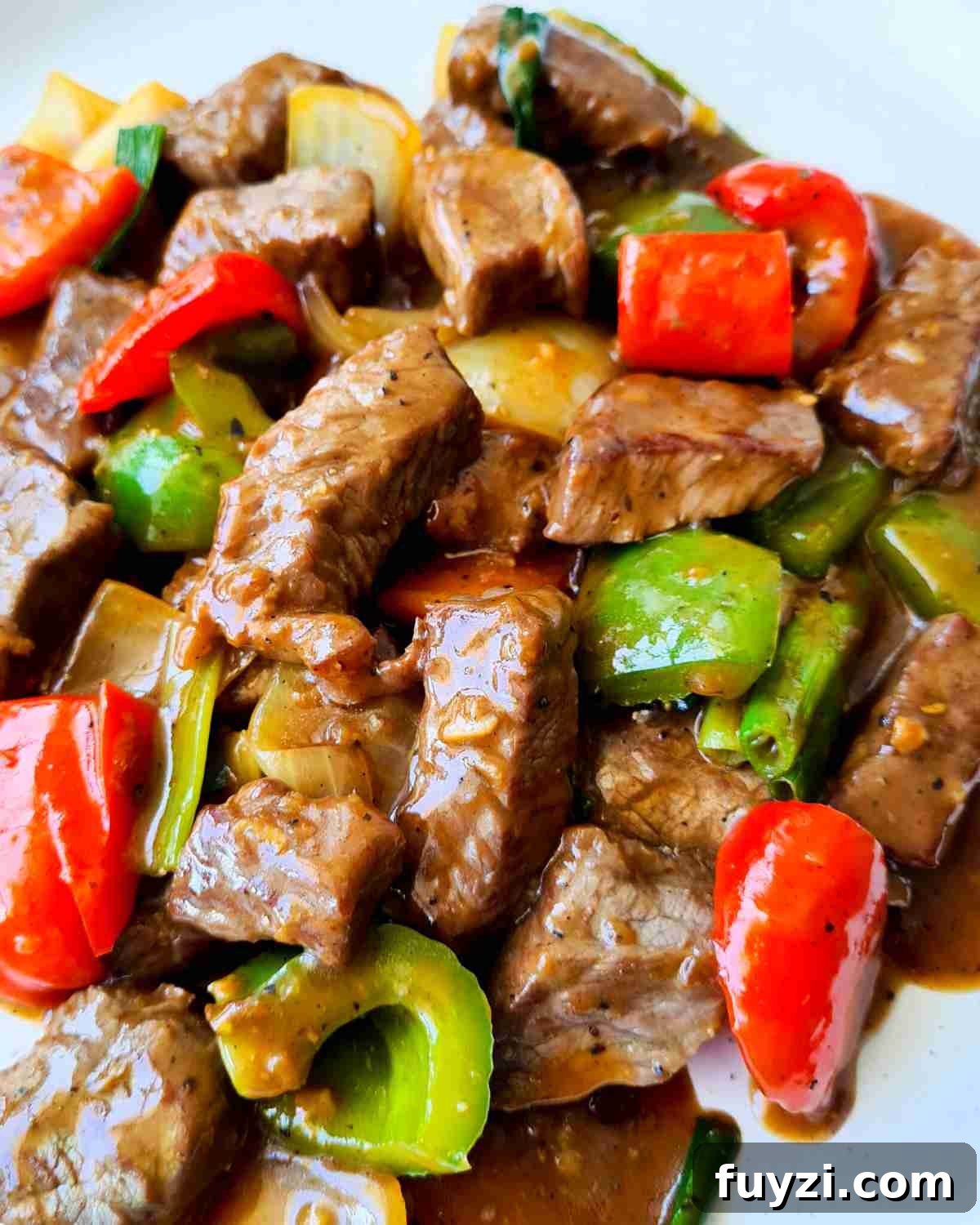 Restaurant-Style Black Pepper Beef Stir-Fry 2 Bite sized beef and capsicums covered in sauce