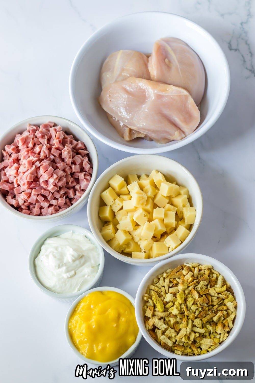 Slow Cooker Chicken Cordon Bleu Recipe with Ham and Swiss 4 bowls of raw chicken breasts, diced ham, diced cheese, sour cream, cream of chicken soup, and dry stuffing mixing