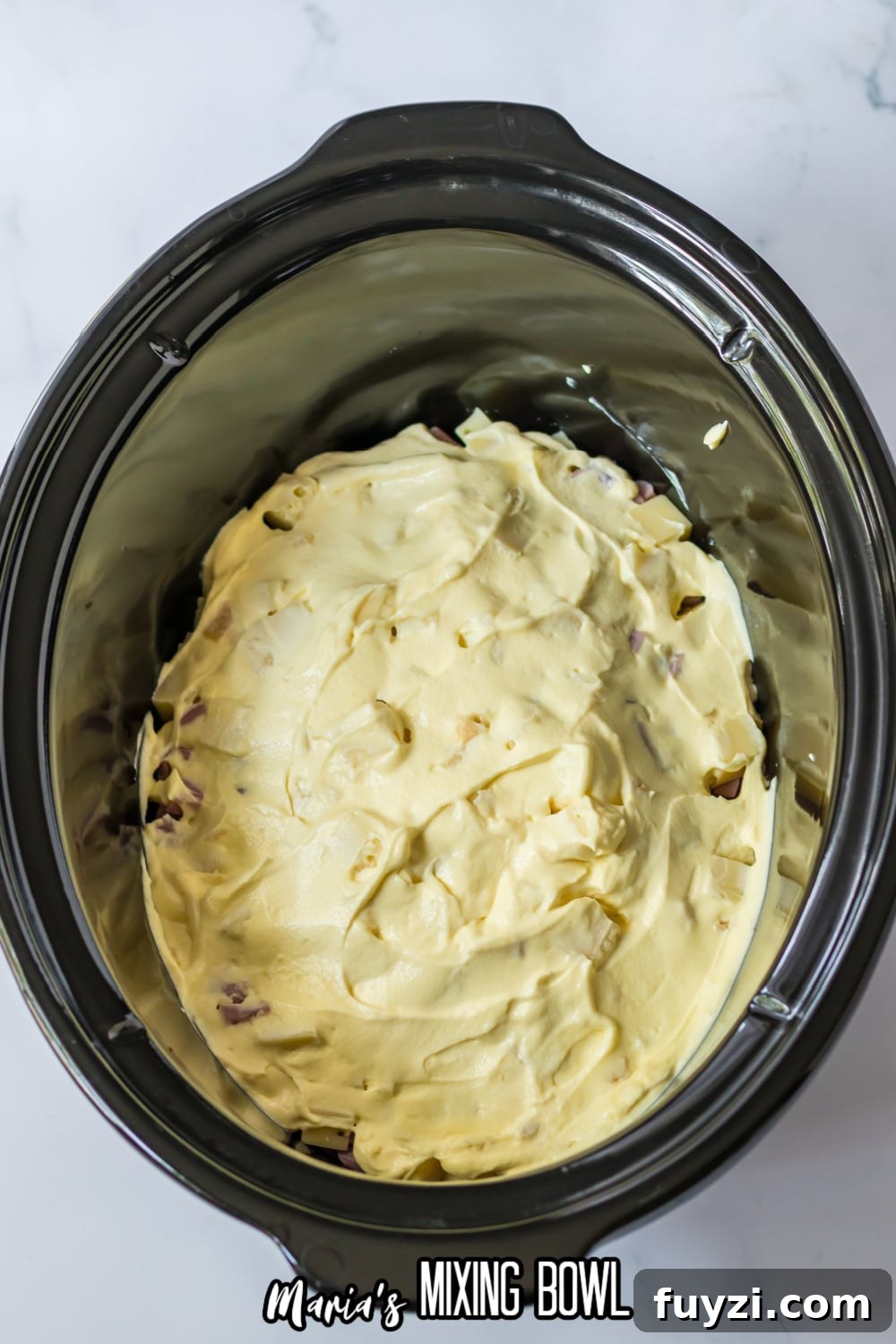 Slow Cooker Chicken Cordon Bleu Recipe with Ham and Swiss 6 raw chicken breasts topped with cream of chicken soup in a slow cooker