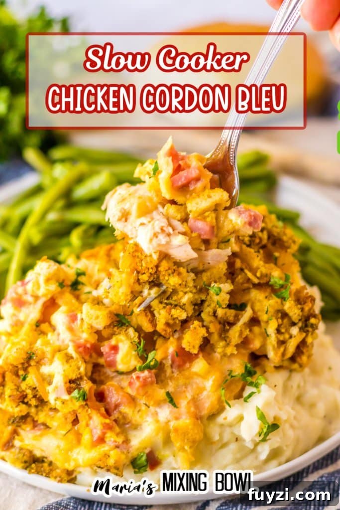 Slow Cooker Chicken Cordon Bleu Recipe with Ham and Swiss 10 fork full of chicken cordon bleu on a plate with mashed potatoes and green beans