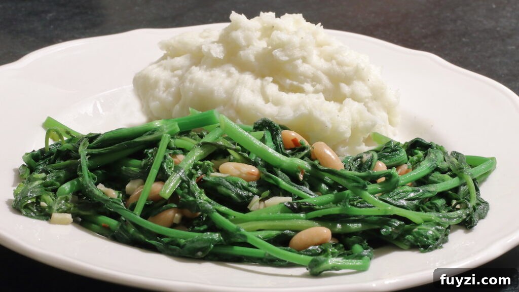 Cooked broccoli rabe with white beans served on a plate