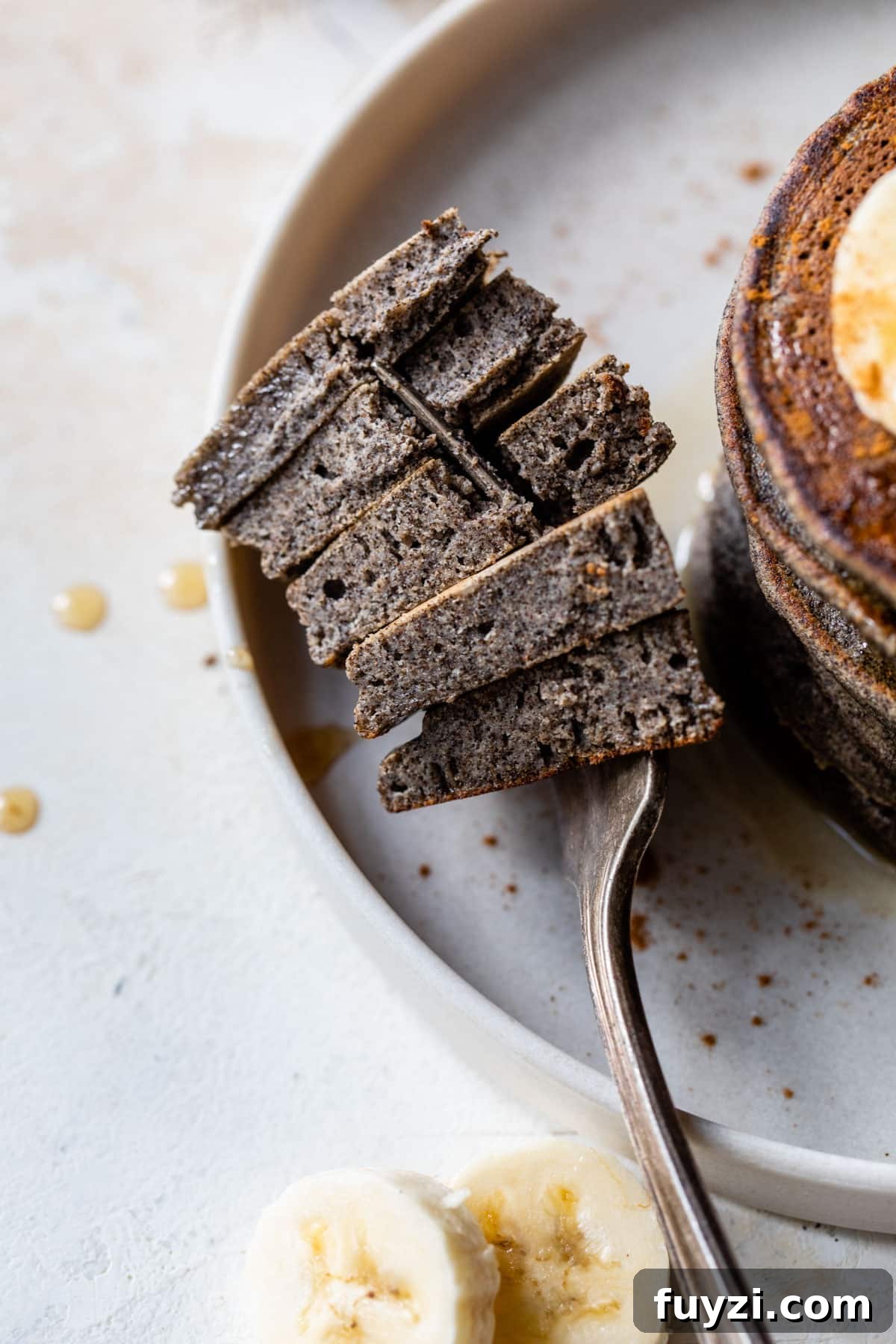 Fluffy Buckwheat Pancakes Recipe with Maple Syrup 5 pancake bites on a fork