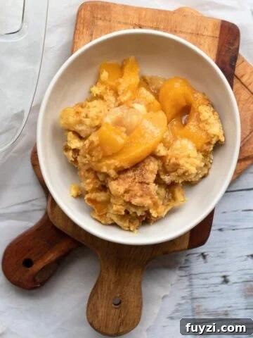 peach cobbler in a white bowl