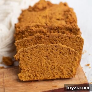Sliced pumpkin bread on a wooden serving board