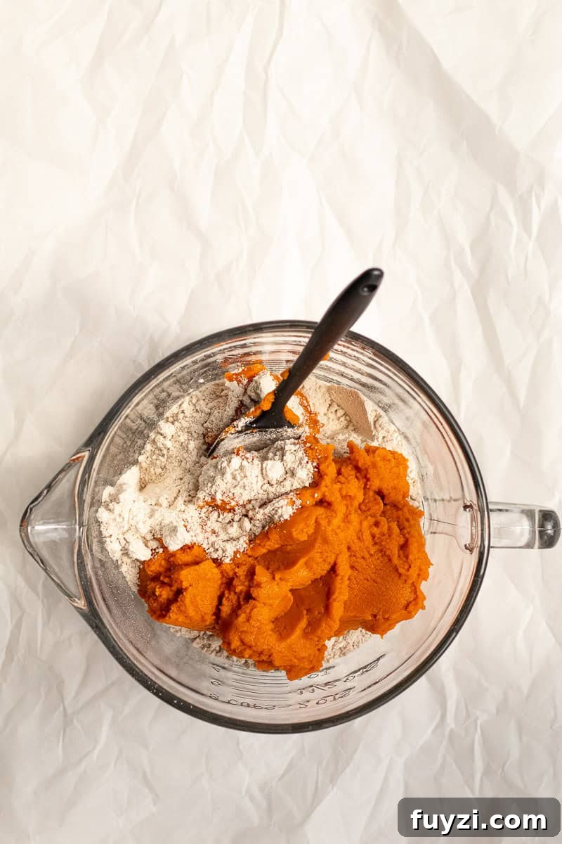 pumkin puree and spice cake mix in a glass bowl
