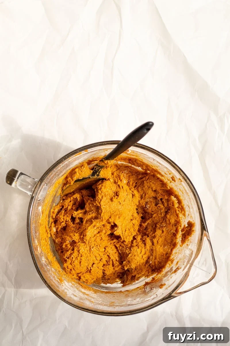 pumpkin bread batter in a glass mixing bowl