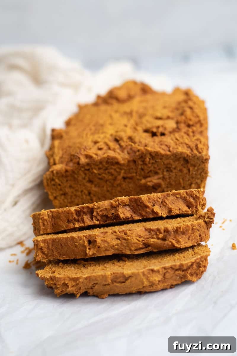 pumpkin bread sliced on parchment paper