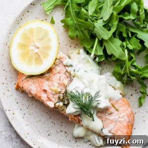 salmon on a plate with tartar sauce.