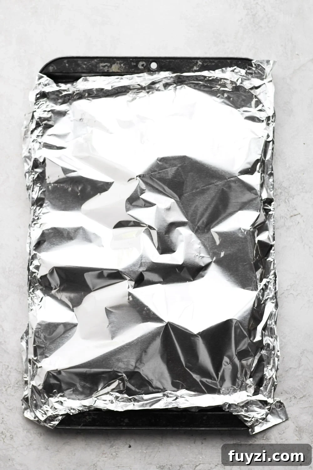 This baked salmon recipe is first marinated in a delicious lemon garlic sauce, then wrapped in tin foil and baked to a flakey perfection! baked salmon covered in foil