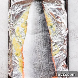 Oven-Baked Salmon in Foil: Flaky, Tender Fillets 3 salmon marinating on foil.