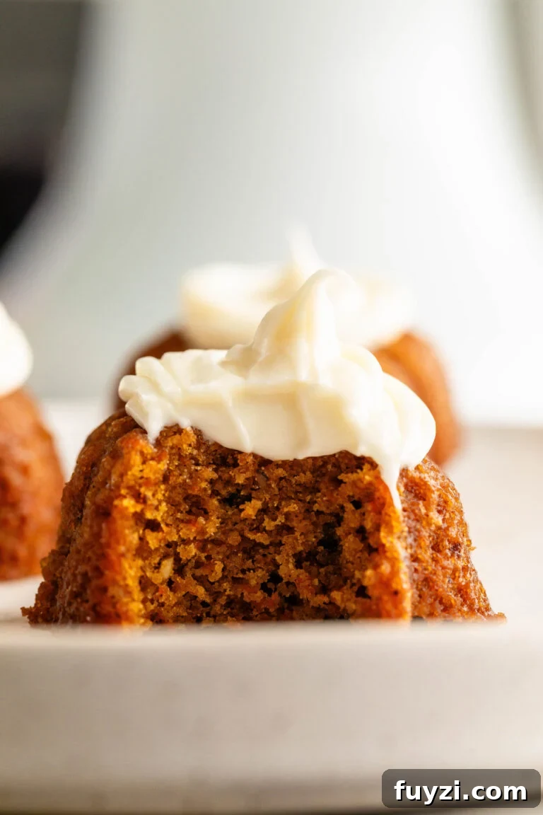 Mini Carrot Cakes topped with Walnuts and Cream Cheese Frosting.