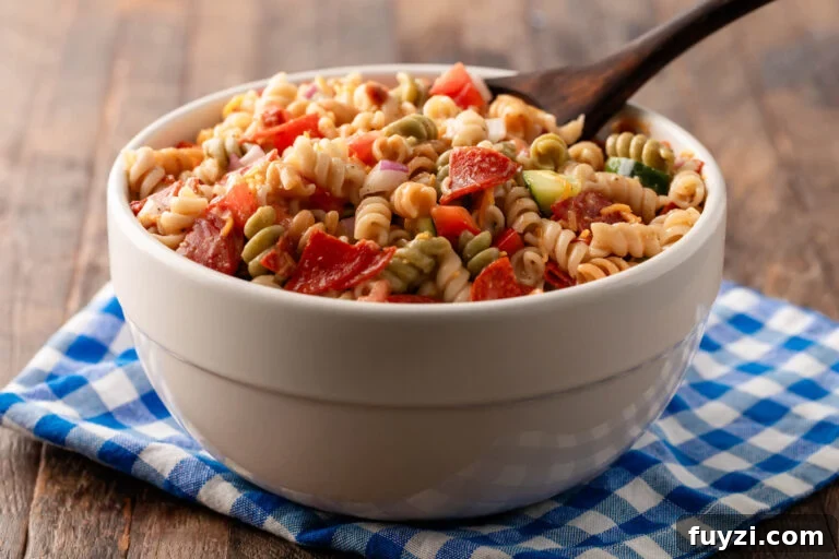 Bowl of Salad Supreme pasta salad with wooden spoon.