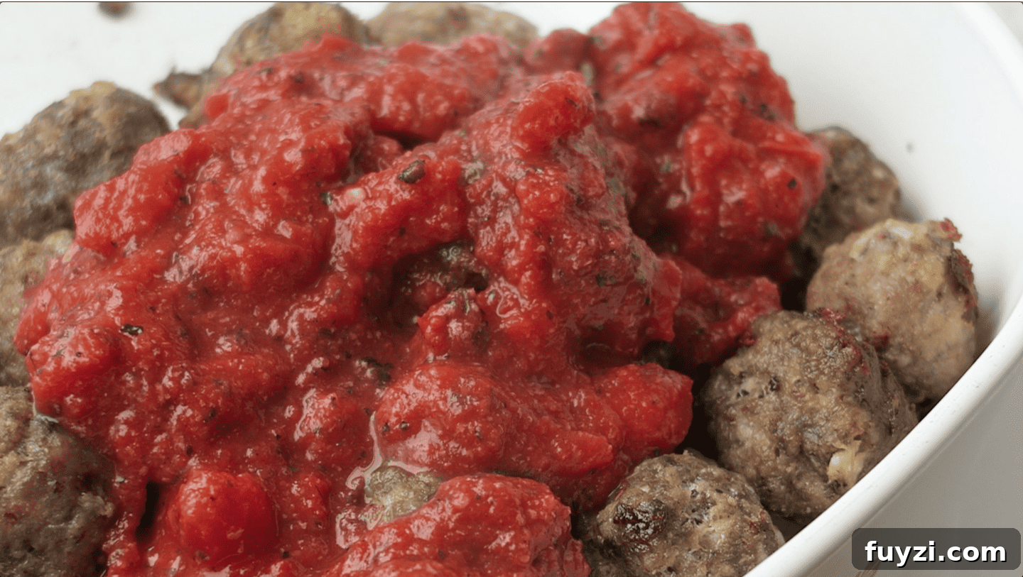15-Minute Vegan Marinara Sauce 7 Marinara sauce poured over baked meatballs